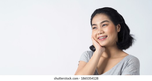 Dental Braces Of Teen Asian Woman Wearing Braces Teeth And Contact Lenses, She Very Confident And Proudly Present Herself And Smile On White Background Studio Shot, Happiness Teenager Smiling Facial