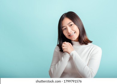 Dental braces of young asian woman wearing braces beauty smile with white teeth increase confidence for healthy on blue background isolated studio shot, Happiness teenager smiling facial expression.