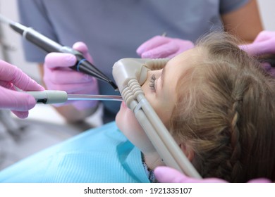 Dental care for children. Superficial sedation. Treatment of children's teeth with nitrous oxide. Photos in the interior of the clinic. Side view. - Shutterstock ID 1921335107