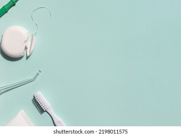 Dental care concept frame with toothbrush, irrigator, tooth floss and toothpaste on the blue background. Copy space	 - Shutterstock ID 2198011575