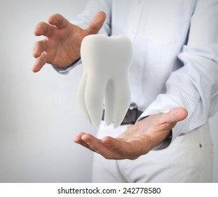 Dental Care Concept: Molar Tooth In Man Hands