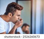 Dental care, man and smell mouth for bad breath in bathroom with morning routine for halitosis problem. Oral hygiene, person and breathing in hand for odor, gingivitis and gum disease in apartment