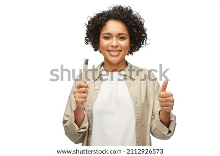 Similar – woman showing wooden toothbrush