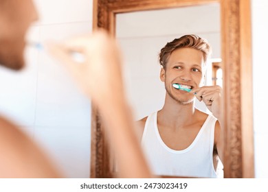 Dental care, smile and man brushing teeth by mirror in home for health, wellness and morning routine. Reflection, oral hygiene and person with treatment for cavity, bacteria and plaque prevention. - Powered by Shutterstock