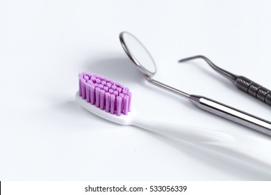 Dental Care Toothbrush With Dentist Tools On White Background