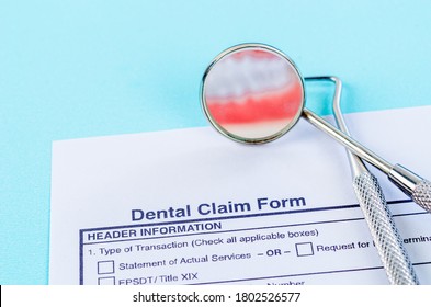 Dental claim Form with model tooth and dental instruments. Dental health and teeth care concept.