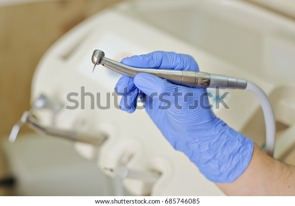 Dental drill in the\
hands of the dentist 