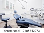 Dental equipment in dentist office in new modern stomatological clinic room. Background of dental chair and accessories used by dentists in blue and white.