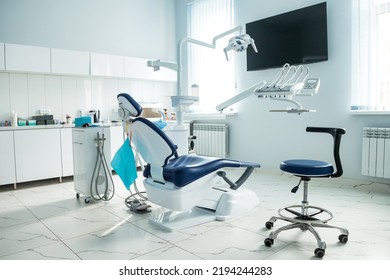 Dental equipment in dentist office in new modern stomatological clinic room. Background of dental chair and accessories used by dentists in blue, medic light. Copy space, text place - Shutterstock ID 2194244283