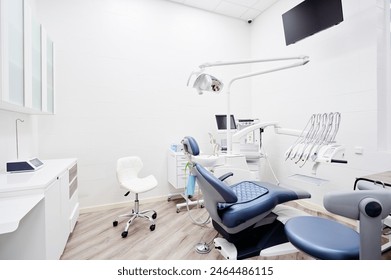 Dental equipment in dentist office in new modern stomatological clinic room. Background of dental chair and accessories used by dentists in blue and white. - Powered by Shutterstock