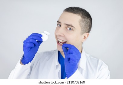 Dental Floss Close Up. Dentist Shows How To Use The Thread Correctly. Different Types Of Flossing. The Concept Of Proper Oral Care. Selective Focus.