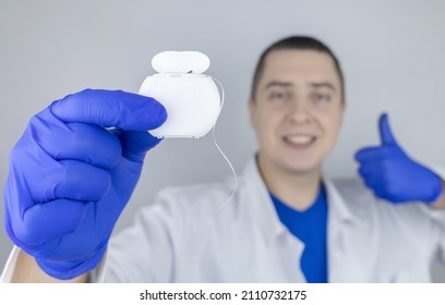 Dental Floss Close Up. Dentist Shows How To Use The Thread Correctly. Different Types Of Flossing. The Concept Of Proper Oral Care. Selective Focus.