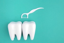 Dental Floss Pick With Teeth Model On Green Background.