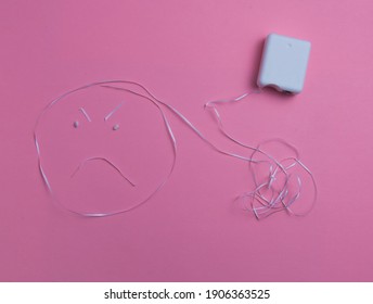 Dental floss in shape of an angry face - Shutterstock ID 1906363525