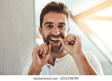 Dental floss, teeth and smile with portrait of man in bathroom for cleaning, morning and oral hygiene. Happy, cosmetics and health with face of person flossing at home for self care, breath and mouth