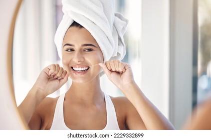 Dental floss, teeth and woman in mirror of bathroom for shower, cleaning and morning routine. Beauty, cosmetics and wellness with face of girl at home for oral hygiene, fresh breath and mouth health - Powered by Shutterstock