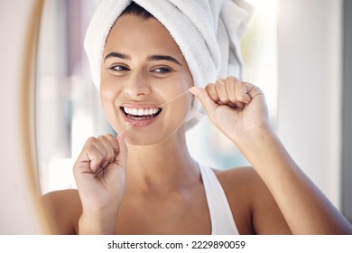 Dental floss, woman and teeth in bathroom mirror for tooth wellness, healthy lifestyle and oral hygiene after morning shower. Happy female, flossing and cleaning mouth, beauty cosmetics and big smile