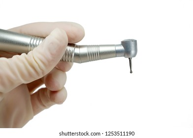 dental handpiece in the hands of the dentist isolated on white background close-up, dental drill, burr - Powered by Shutterstock