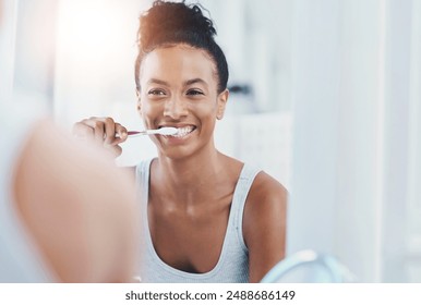 Dental hygiene, bathroom and woman brushing teeth for health, wellness and morning routine. Oral care, teeth whitening and female person with clean mouth treatment for fresh breath by mirror at home. - Powered by Shutterstock