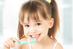 Dental Hygiene. Happy Little Girl Brushing Her Teeth