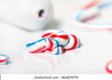 Dental Hygiene Product. Tricolor Toothpaste On Light Background. Tooth Care Cream Smudge Close-up