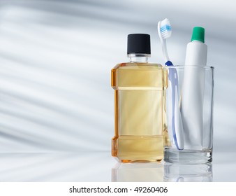 Dental Hygiene Products On Grey Background With Copy Space