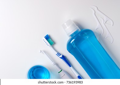 Dental hygiene. Toothbrush, mouthwash, dental floss, oral irrigator. Flat top view - Shutterstock ID 736193983