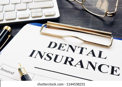 Dental Insurance Form And Pen On A Desk.