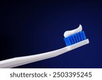Dental king concept. Hygiene. Professional photo. White toothbrush with toothpaste on a dark blue background. 