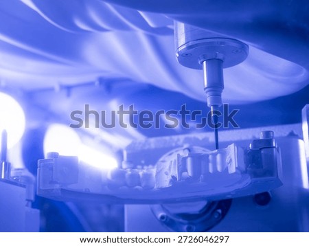 Dental milling machine processing ceramic crown with precision CNC tool in modern CAD CAM laboratory for digital dentistry, prosthetics and automated dental manufacturing