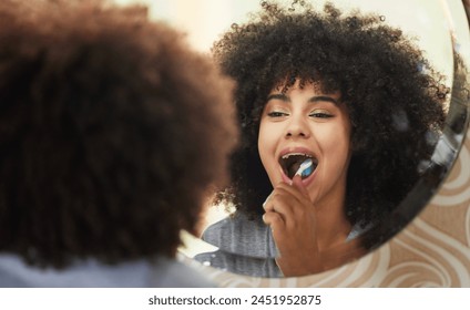 Dental, mirror and woman brushing teeth in bathroom for health, wellness and self care in morning at home. Oral care, reflection and female person with mouth routine or treatment in apartment. - Powered by Shutterstock