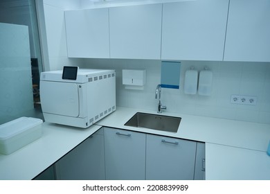 Dental Office With Cabinets, Sink And Instrument Sterilization Equipment