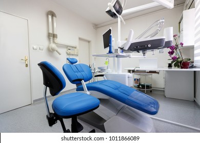 Dental ordination with blue dental chair and apparatus - Shutterstock ID 1011866089