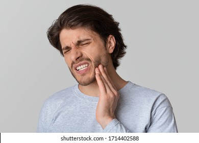 Dental problems concept. Man suffering from bad toothache, empty space