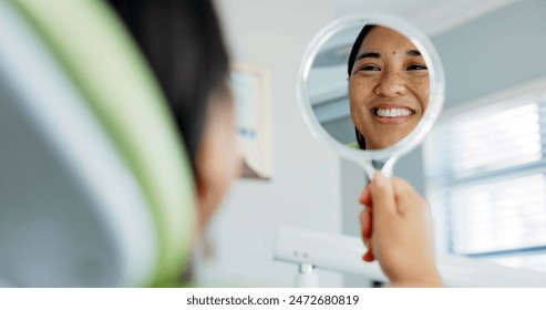 Dental, smile and happy woman with mirror check at a dentist for teeth whitening results. Mouth, oral care and Asian female client with tooth, cleaning or routine checkup in Tokyo with satisfaction - Powered by Shutterstock