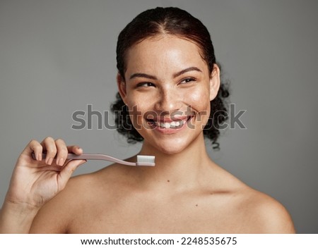Dental smile, toothbrush and woman brushing teeth for hygiene, cleaning and teeth whitening in studio. Happy female face on grey background for oral health, healthy mouth and self care for wellness