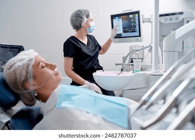 Dental surgery in modern dental clinic.. Woman patient is waiting for operation in the dentist chair. - Powered by Shutterstock