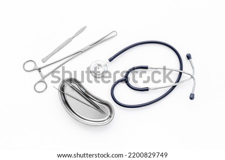 Dental or surgical instruments in steel tray at doctor desk