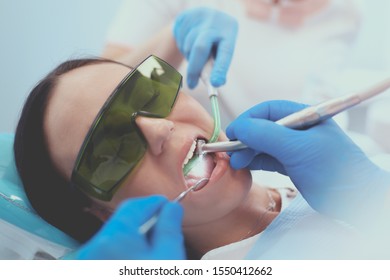 Dental team and patient at dentist's surgery - Shutterstock ID 1550412662