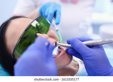 Dental team and patient at dentist's surgery - Shutterstock ID 1613335177