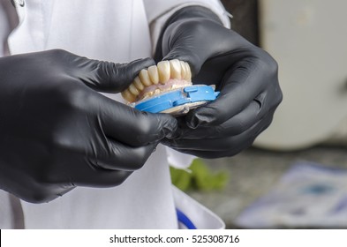 Dental Technician Holding A Monolithic Zirconia Restorations Full Arch Implant  Supported With The Ceramic Load In Vestibular.