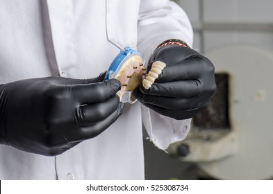 Dental Technician Holding A Monolithic Zirconia Restorations Full Arch Implant  Supported With The Ceramic Load In Vestibular.