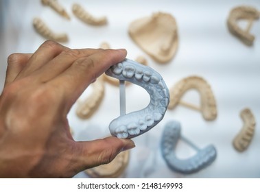 Dental technician modeling frame for implant production from a 3d printer at the laboratory