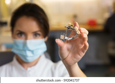 Dental Technician Presenting Dental Prosthesis In A Lab