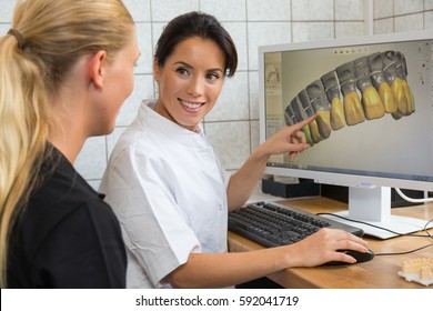 Dental Technician Showing Patient A Scan Of Prosthesis On Computer Screen