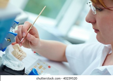 Dental Technician Working On Ceramic Inlays In A Lab