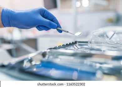 Dental tool and other accesries used by dentists in the office. Detail of hand holding dental tools in dental clinic. Dentist Concept. Dentists with a patient during a dental intervention. - Powered by Shutterstock