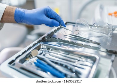 Dental tool and other accesries used by dentists in the office. Detail of hand holding dental tools in dental clinic. Dentist Concept. Dentists with a patient during a dental intervention. - Powered by Shutterstock