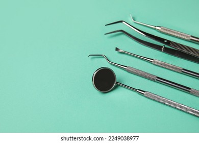 Dental tools on green background, closeup