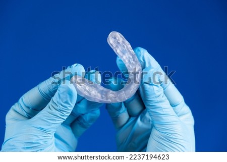 Dental transparent plastic mouthguard, splint for the treatment of dysfunction of the temporomandibular joints, bruxism, malocclusion, to relax the muscles of the jaw. Stock photo © 